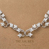 Silver Cleo wedding hair accessory with Swarovski white opal marquise crystals arranged in floral clusters along a symmetrical crystal-encrusted bridal hair vine.