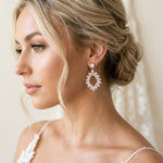 Bride wearing Treasures by Agnes Odette bridal earrings featuring sparkling marquise cut cubic zirconia in an elegant open teardrop design.