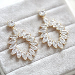 Treasures by Agnes Odette bridal earrings featuring marquise cut cubic zirconia in a gold plated open teardrop design displayed on a soft velvet jewelry box.
